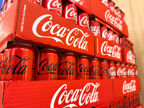 Villach, Austria - January 29, 2026: Stacked Coca-Cola cans in red packaging, showcasing various flavors including zero sugar, arranged in a retail display