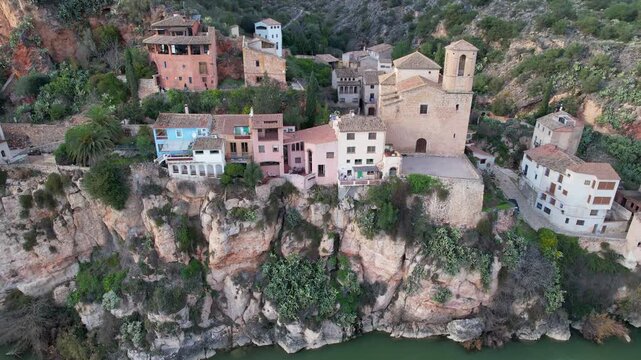 Orbital aerial shot of Miravet castle and Ebro river on winter day. Tarragona, Spain.