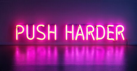 Obraz premium Bright pink neon sign displays PUSH HARDER against dark wall. Reflections visible on glossy surface below text. Minimalist aesthetic.