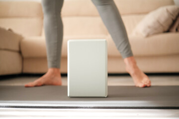 Middle aged woman doing exercises at home. Active lifestyle and fitness equipment for wellness...