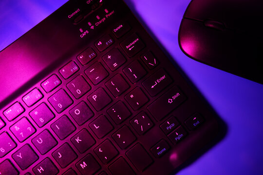 Vibrant neon lighting on keyboard and mouse interface