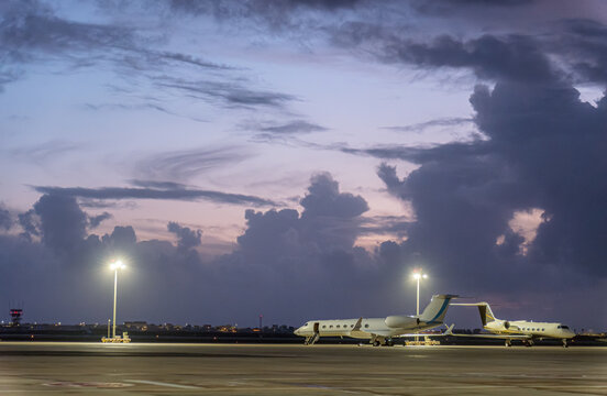 Faro Airport runway at twilight with planes
