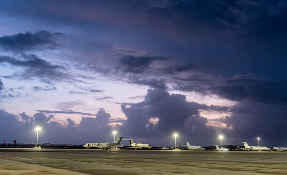 Aircraft parked at Faro's Airport amid a dramatic sky