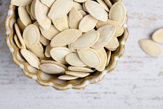 Pumpkin seeds in a decorative ceramic bowl