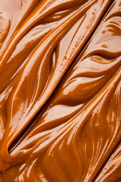 Silky swirls of rich salted caramel background