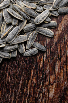 Salted sunflower seeds on rustic wooden surface