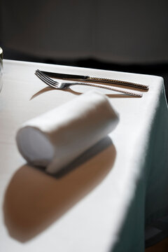 Elegant table setting with rolled napkin and cutlery