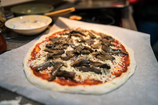 Fresh homemade mushroom pizza on parchment paper