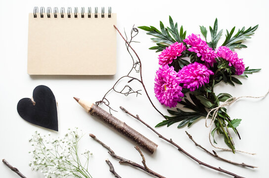 Flatlay of notebook and flowers with rustic elements
