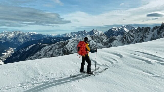 Beautiful Winter Dolomite Mountain Scenery with Man on Cross-Country Skis , Aerial View