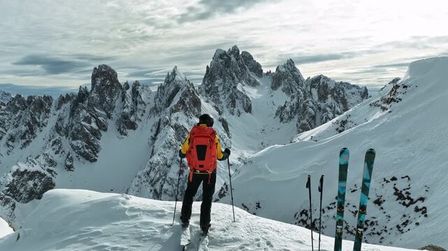 Beautiful Winter Dolomite Mountain Scenery with Man on Cross-Country Skis , Aerial View