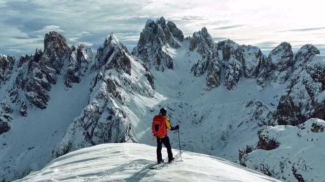 Beautiful Winter Dolomite Mountain Scenery with Man on Cross-Country Skis , Aerial View