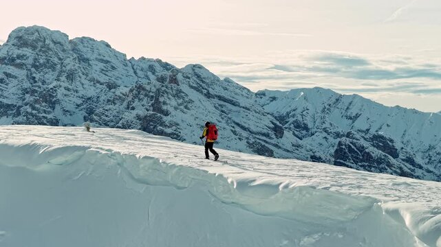 Beautiful Winter Dolomite Mountain Scenery with Man on Cross-Country Skis , Aerial View