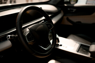Modern car interior with steering wheel and dashboard controls visible