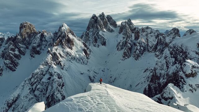 Beautiful Winter Dolomite Mountain Scenery with Man on Cross-Country Skis , Aerial View