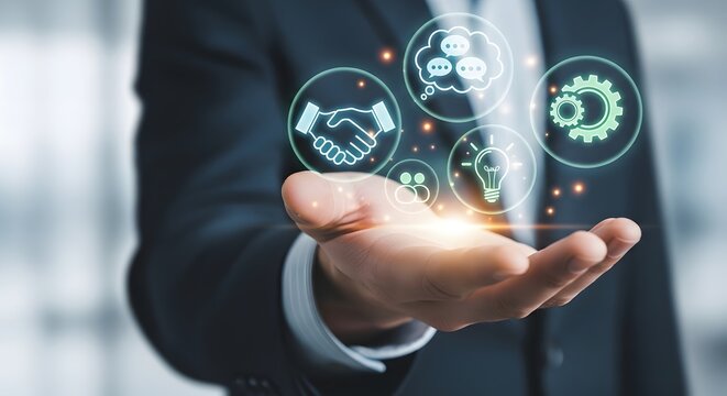 Hand holding digital icons representing business concepts like partnership, communication, and innovation