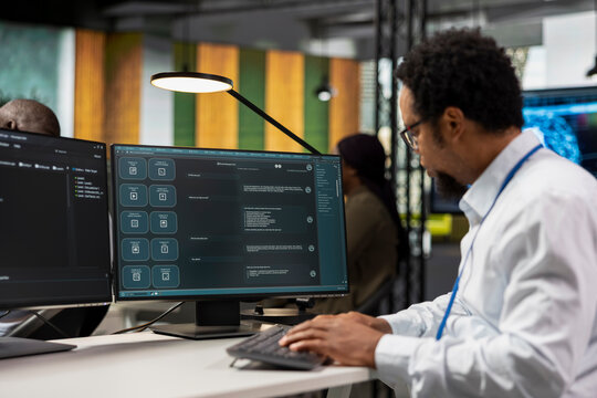 Close up of IT employee in office automating repetitive tasks using AI LLM chatbot assistance. Startup computer scientist uses machine learning large language model assistant on PC