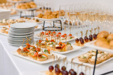 Elegant catering display with assorted appetizers and champagne glasses © bo.kvk