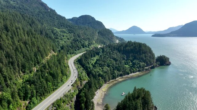 Aerial View of Sea to Sky Highway Curving Above Turquoise Cove, Howe Sound British Columbia Canada