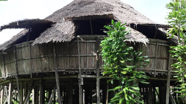 Bidayuh longhouse Sarawak Cultural Village in Kuching, Malaysia. It is a round head-house with bamboo galore and carvings known as the Barok