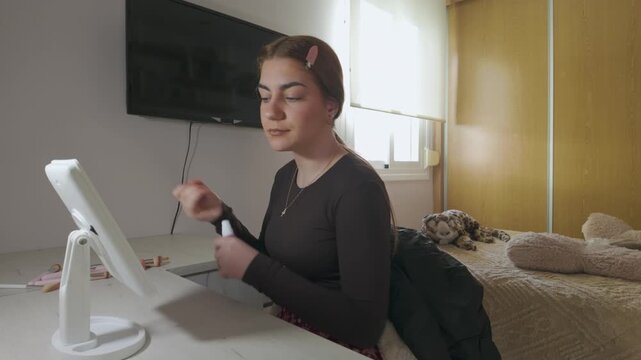 Young woman applying face mist during skincare routine