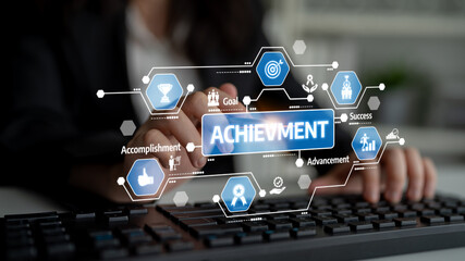 A business professional interacts with a keyboard while a digital interface displays achievement...