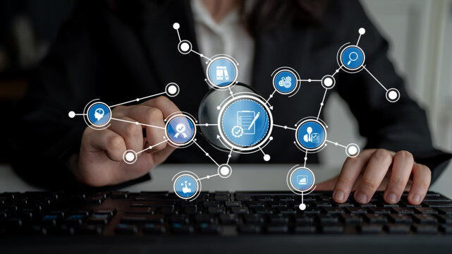 A business professional engages with digital connections and data analytics by navigating a keyboard amidst innovative graphics, showcasing modern technology in the office. Tessel