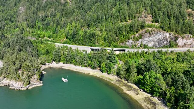 Dynamic Orbital Aerial of Sea to Sky Highway Above Secluded Cove, Howe Sound British Columbia Canada