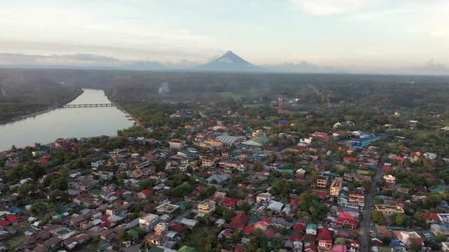 Aerial view of Donsol town at sunset with Mayon Volcano in the distance, Philippines