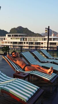 Traveler relaxing on a cruise deck in Ha Long Bay, Vietnam