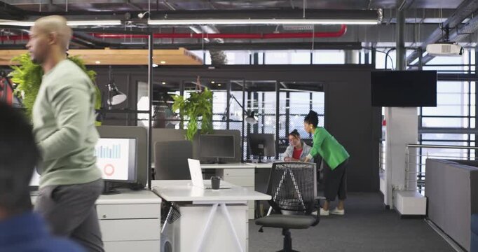 After coffee and papers, mature male at desk lifting smartphone while typing and referencing charts
