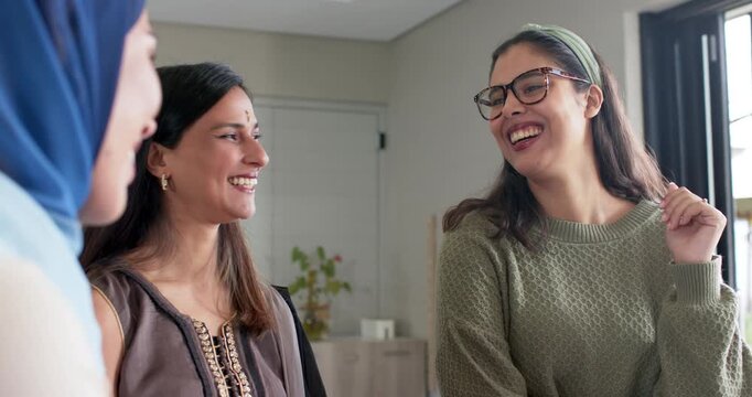 Diverse female friends welcoming newcomer after her entering, laughing together by entrance console