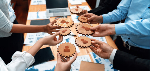 A dynamic scene of multiple hands holding gears with people icons, emphasizing collaboration and...