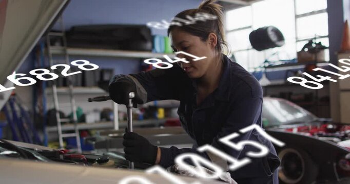 Woman tech placing socket, turning wrench for repair with numeric overlay partially obscuring front