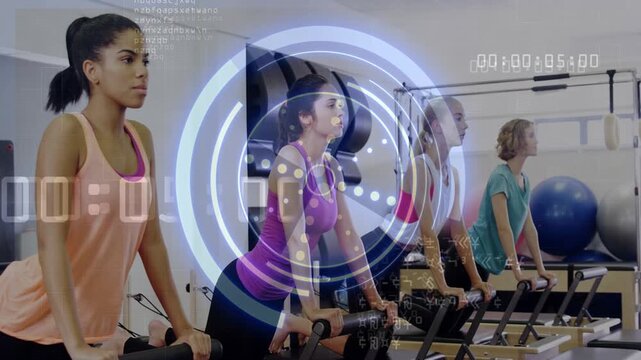 Four women on reformers doing pilates in sync after HUD appearing, shifting for core strength
