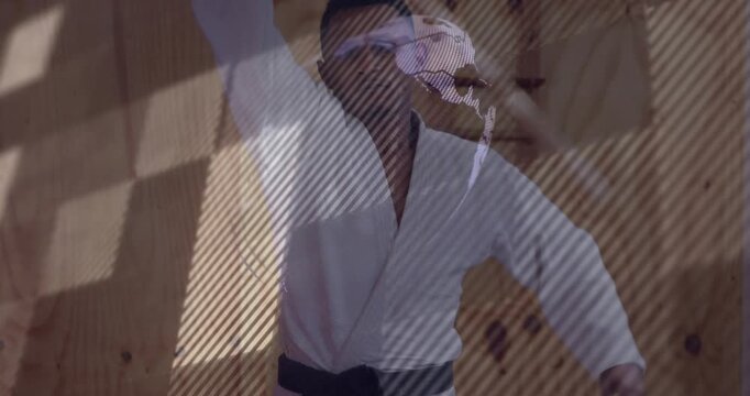 Martial artist drawing bokken from low, training while globe overlay crossing torso guiding thrust