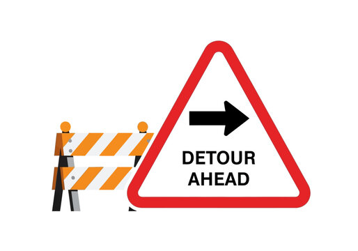 Traffic detour ahead sign and barrier indicating road closure and rerouting