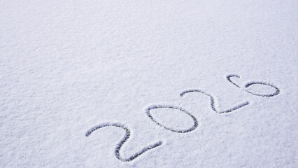 Written sketch for new year 2026. Snow background numbers ice outdoor on ground in winter. Writing text sign and drawing on field in nature frozen background. Copy space for text