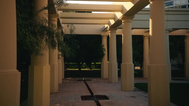 Covered colonnade walkway with pillars and shadows