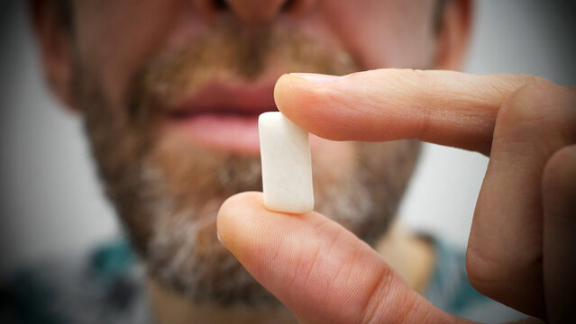 Close-up of a chewing pad in the hand of a man