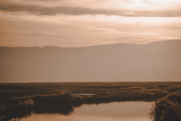 Obraz premium golden hour over the river and grasslands over Bear River Bird Refuge in Utah