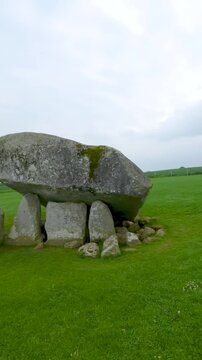 Aerial vertical FPV view of the Brownshill Dolmen, officially known as Kernanstown Cromlech, a magnificent megalithic granite capstone, weighing about 103 tonnes, located in County Carlow, Ireland