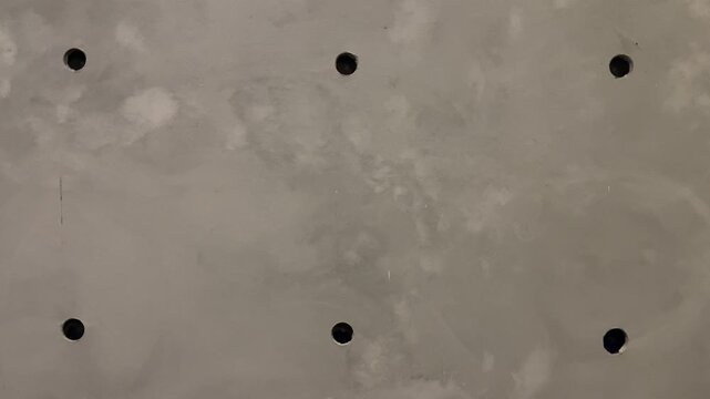 Texture concrete wall of light grey color cement texture background. Grey pastel rough crack cement texture stone concrete,rock plastered stucco wall; painted flat fade background. Side view. 