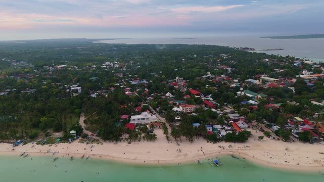 Aerial drone view at sunset of the pristine white sand beaches and emerald waters of Bantayan Island, Cebu, Philippines travel destination