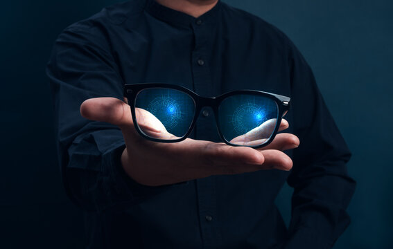 AI-enhanced smart glasses concept with futuristic digital interface reflection. Augmented reality, real-time data analysis, facial recognition, wearable technology and intelligent vision systems.