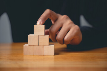 A powerful sign of growth, this closeup shows a man hand pose in a gesture to build a pyramid, a clear business sign of strategic planning and future achievement