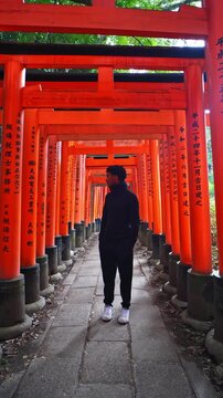 Traveler experiencing the sacred torii gates of Japan