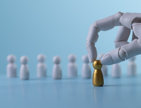 AI Robot Selecting a Golden Figure for Premium Recruitment Concept