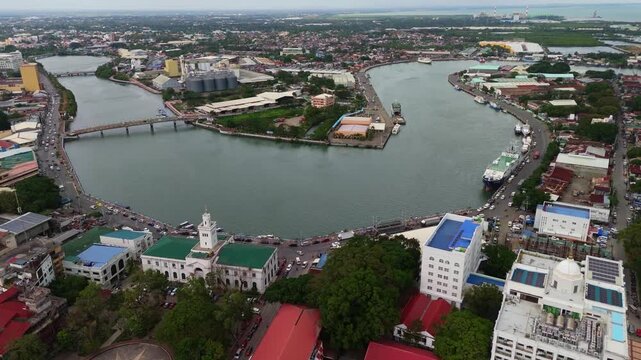 aerial drone urban heart of Iloilo City, featuring the main heritage plaza and the revitalized river landscape on Panay Island