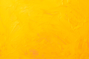 黄色い絵の具でペイントされたキャンバスの背景テクスチャー